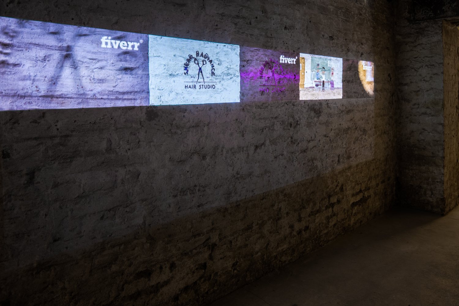 The Wrong Club — Sebastian Schmieg: logos projected along a concrete wall