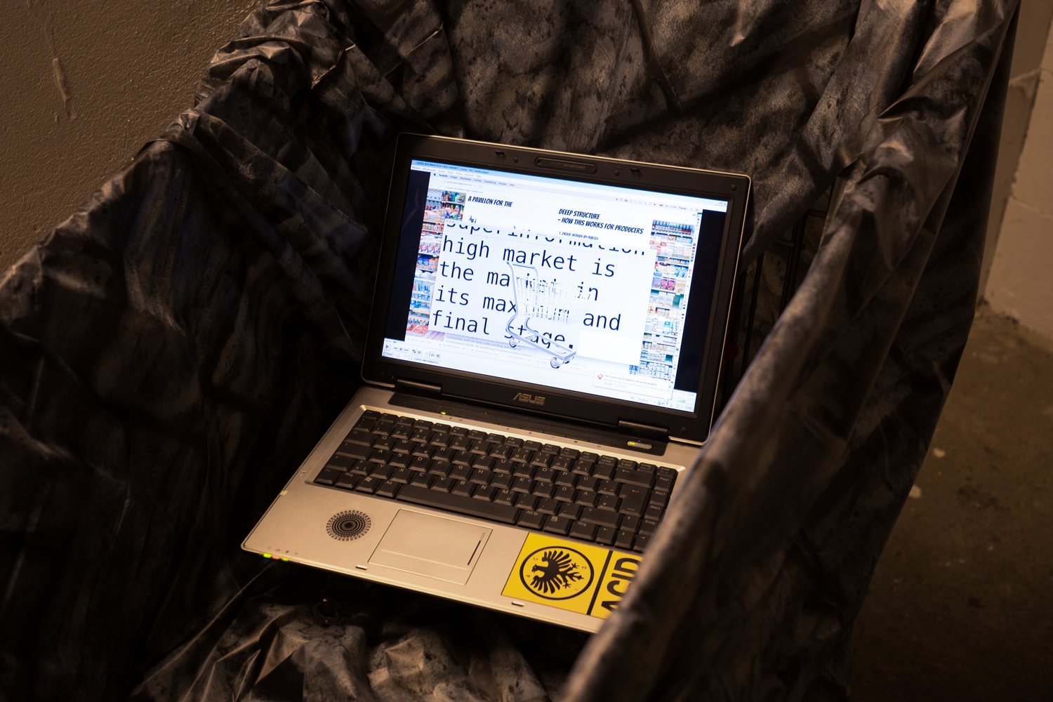Super Information High Market — a laptop in a draped shopping cart, video still
