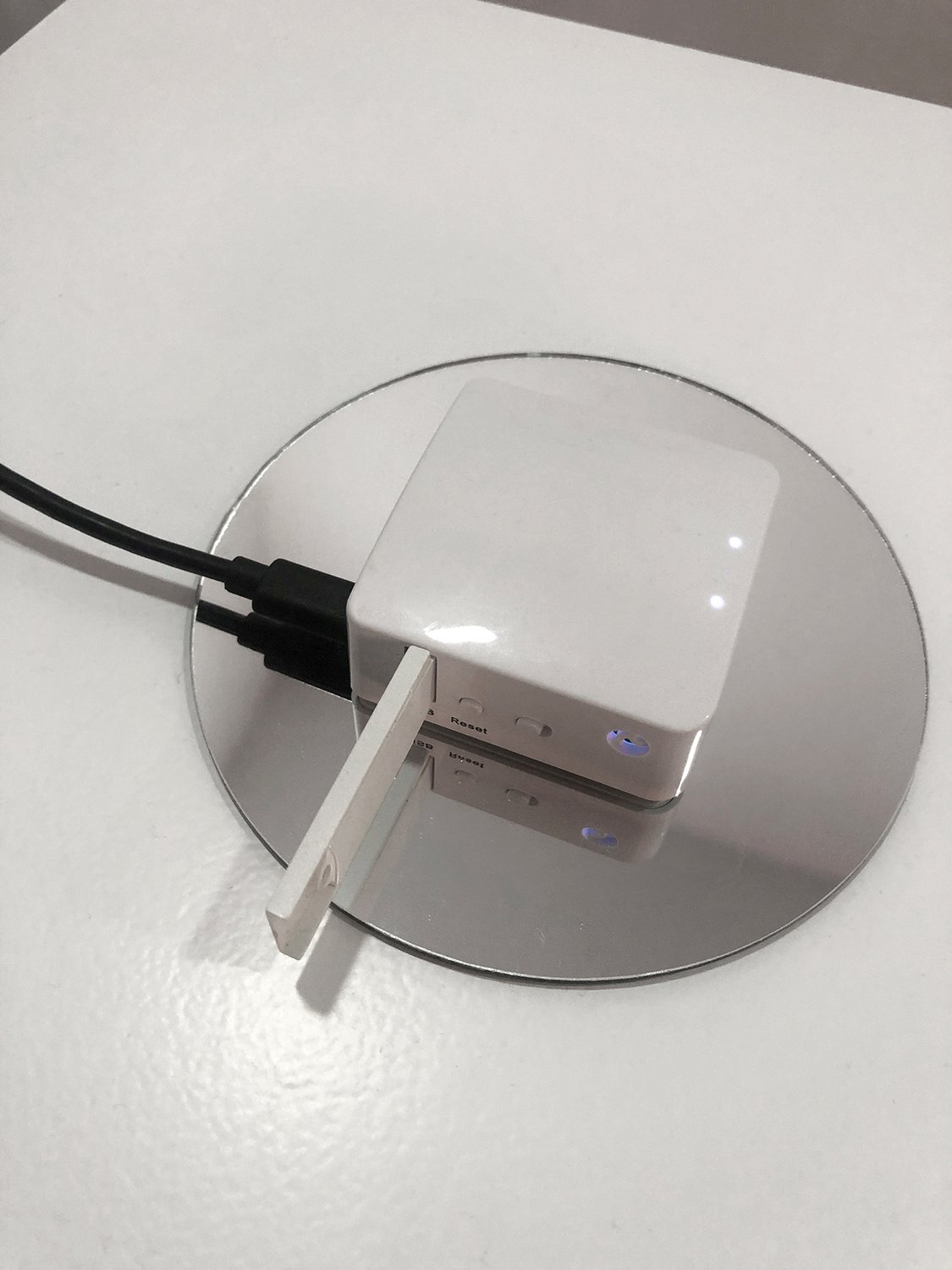 The Wrong Router — Achim Mohné's white router object on a round mirror