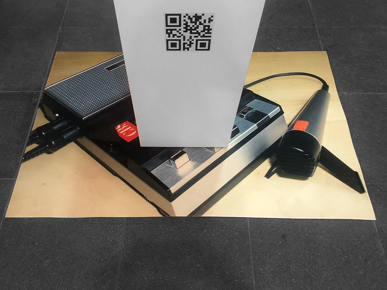 The Wrong Router — floor print of a vintage cassette recorder with QR-code plinth